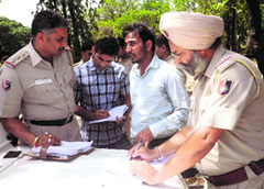 Police officials record the statements of students after the firing incident on the PU campus on Friday.