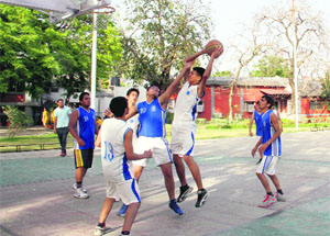A player tries to basket the ball in the district sub-junior basketball tournament being played at Welham Boys School in Dehradun on Friday.