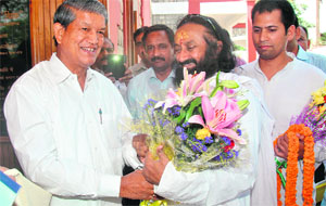 Chief Minister Harish Rawat greets spiritual guru Sri Sri Ravishankar in Dehradun on Friday.