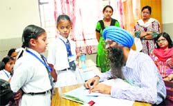 DEO Dr Charanjit Singh interacts with students at Bal Bharti School in Ludhiana on Friday. Tribune Photo: Himanshu Mahajan
