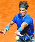 Nadal of Spain returns the ball to Nieminen of Finland during their match at the Madrid Open tennis tournament. AFP