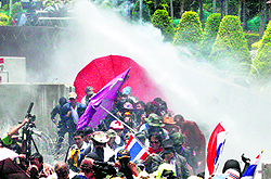 Police fire teargas and water cannon at anti-government protesters in Bangkok on Friday