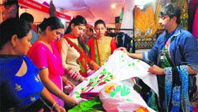 Women look at clothes during the third day of The Pakistan Show at a shopping mall in Amritsar on Saturday.