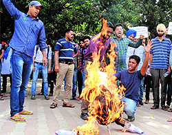 Members of the Students for Society (SFS) burn an effigy of the UT Administration to vent their ire against the demolition of colonies, at Student Centre in Panjab University, Chandigarh, on Saturday