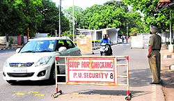 A security guard allows a car to enter without checking at the Gate Number 1 of Panjab University on Saturday