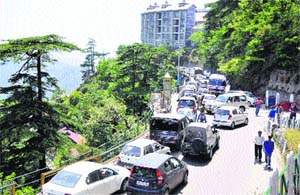 Vehicles stand in a long queue due to traffic jam in Shimla on Saturday. Photo: Amit Kanwar