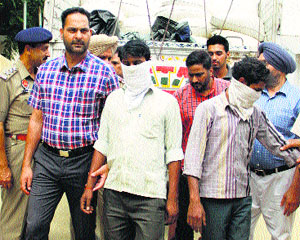 The police with the accused held for smuggling 110 bags of poppy husk in Jalandhar on Saturday.