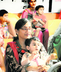 A woman attends a Mothers Day function with her little one at Maple Bear Playway in Ludhiana.