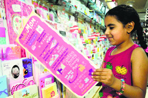A girl takes a look at a greeting card. 