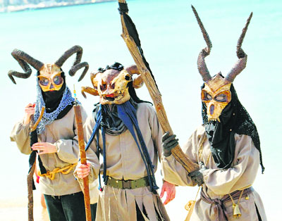 People dressed as devils perform as they protest against oil exploration off the coast of the Balearic Islands, at Playa de Palma in Palma de Mallorca.