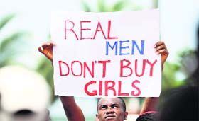 A man holds a placard as youths protest the release of abducted school girls in the remote village of Chibok in Lagos on Saturday.