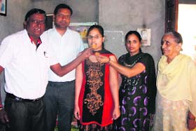 Anuradha celebrates with her family after securing her name in the merit list of the PSEB Class XII results in Bathinda on Sunday
