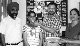 Family members offer sweets to Varinder Kaur after the declaration of results in Mohali on Sunday.