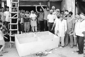 Residents hold a protest at Kumbhra village in Mohali on Sunday.