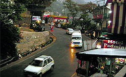 People drive vehicles with headlights on at 1.30 pm due to an overcast sky in Dharamsala on Sunday
