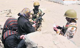 Security personnel check voter slips in Leh on Wednesday.