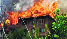 Fire engulfs residential houses at the Zampa Kadal locality in Srinagar on Sunday.