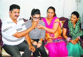 Muskan Verma with her parents at their home in Fazilka on Sunday