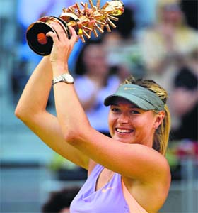 Maria Sharapova poses with the trophy after winning the final against Simona Halep at the Madrid Open on Sunday