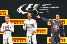Lewis Hamilton (centre), Nico Rosberg (left) and Daniel Ricciardo celebrate on the podium after finishing first, second and third respectively in the Spanish Grand Prix in Barcelona on Sunday