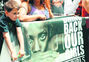 A boy takes part in a prayer vigil for abducted Nigerian schoolgirls in front of the Consulate General of Nigeria in Manhattan.