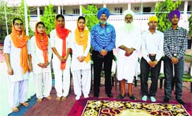 Basking in glory: Students of Baba Gurmukh Singh Uttam Singh Senior Secondary School, who secured merit positions in X+II of the  Punjab Education Board, with Baba Sewa Singh Kaar Sewa Wale