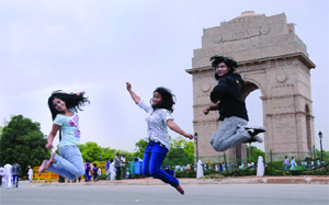 People enjoy the cloudy weather at India Gate in New Delhi on Monday