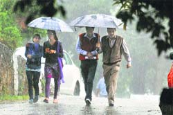 People were out with umbrellas after it rained in Shimla on Monday. Photo: Amit Kanwar