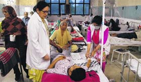 A nurse takes care of a patient at the Civil Hospital in Jalandhar on Monday.