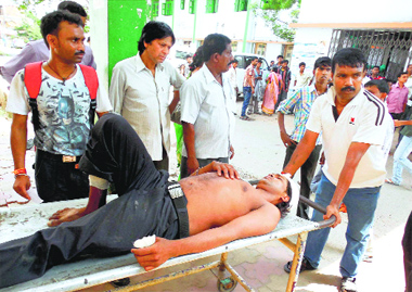 An injured person being taken to a hospital at Haroa in West Bengal on Monday.