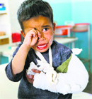 A wounded child cries after receiving treatment following an attack in Ghazni province on Monday