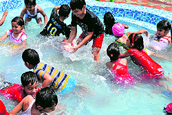 Children enjoy at a splash pool party at Mind Tree School in Kharar on Tuesday