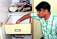 A man shows the empty cash drawer at a house where a theft took place in Sector 7, Panchkula, on Monday