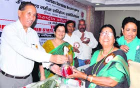 CS Subhash Kumar awards a retired nurse S Daniel on the occasion of Nurses Day in Dehradun on Monday.