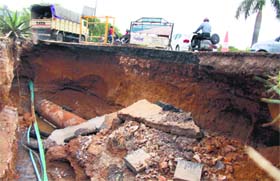 Dangerous drive: A road caved in after a water pipeline burst near Atul Kataria Chowk in Gurgaon on Monday. The movement of traffic remained disrupted for over an hour