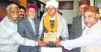 The shilpa parishad felicitates Musafir Ram at Chamba on Tuesday. Photo: Balkrishan Prashar 