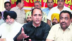 Members of the All Punjab Truck Operators Union address the media in Jalandhar on Tuesday. photo: Sarabjit Singh