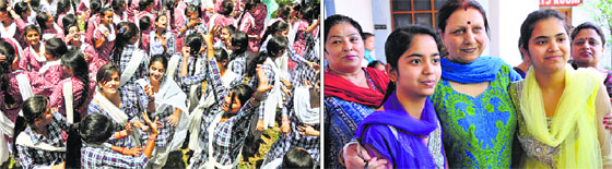 Students of Government Girls Higher Secondary School, Mubarak Mandi, in a jubilant mood after the declaration of Class XII exams result; and (right) principal Shashi Prabha Thapa hugs two meritorious students on Tuesday.