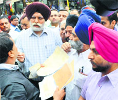 The Ludhiana Mayor talks with shopkeepers at Chaura Bazar.