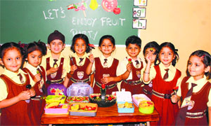 Students of MGM Public School celebrate Fruit Day on the school premises in Ludhiana.