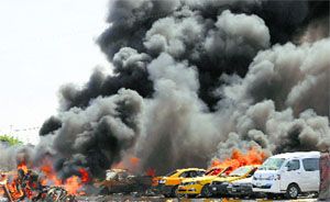 Burning vehicles are seen moments after one in a series of bombs hit the Shiite stronghold of Sadr City in Baghdad on Tuesday. 