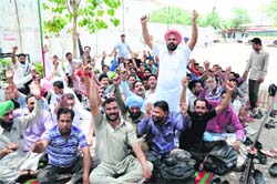 Members of the PRTC Workers Union (Azad) shout slogans during their protest in Bathinda on Wednesday. Tribune photo