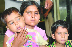 Anshul (L) with his mother during a press conference in New Delhi on Wednesday. (R) Another boy was also rescued. 