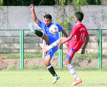 Players vie for the ball in a match in the Dehradun District Football League played at Pavilion Ground in Dehradun on Wednesday