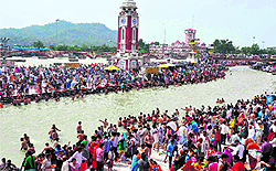 Devotees take a holy dip at Brahamkund, Har-ki-Pauri, in Haridwar on Wednesday