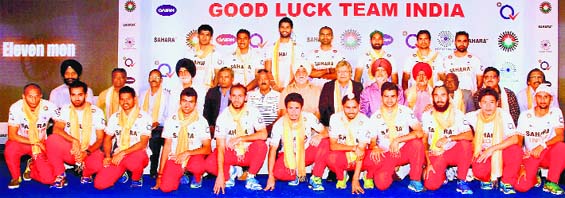 The Indian hockey squad for the 2014 World Cup poses with the 1975 World Cup winners at a function in New Delhi on Wednesday. PTI 