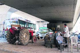 Materials of an automobile transport workshop under the elevated stretch of GT Road in Amritsar