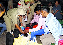 The police check belongings of passengers at the railway station in Bathinda on Thursday