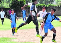 Players of Delhi Public School and Shishu Niketan School vie for the football during a match at Saint Soldier International School in Sector 28, Chandigarh, on Thursday. Tribune photo: Parvesh Chauhan