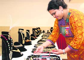 GOLD AND FAITH: A woman have a look at jewellery at an exhibition in Dehradun on Thursday